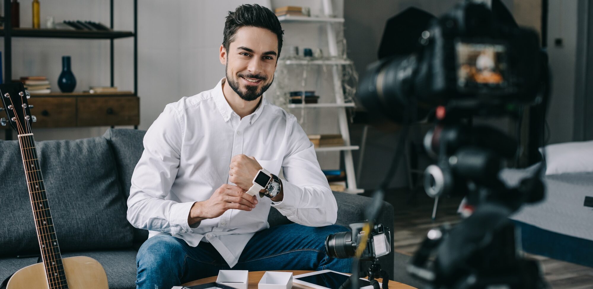 smiling technology blogger putting on new smart watch
